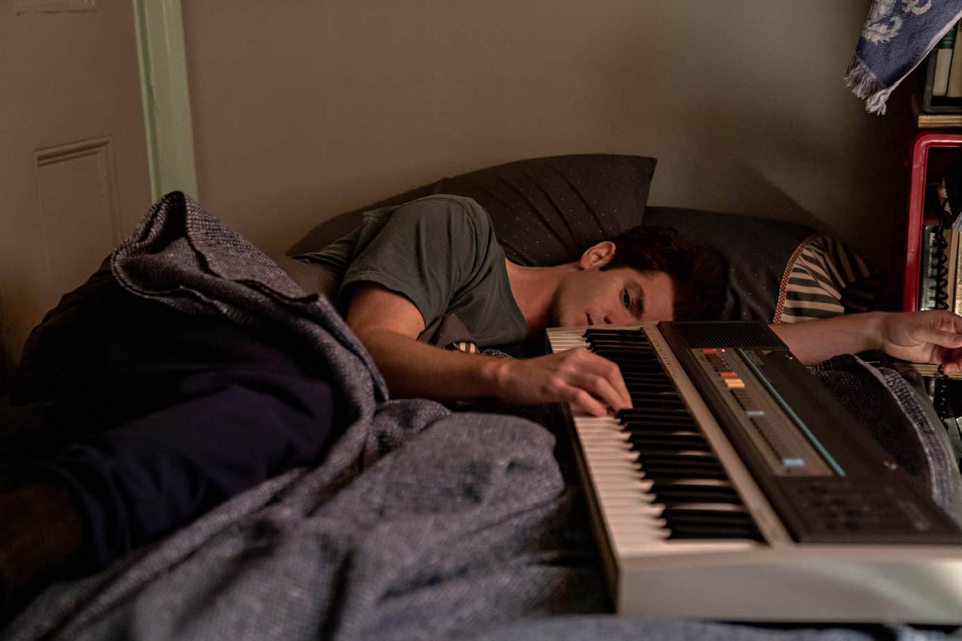 is tick tick boom kid friendly? man laying in bed with a keyboard next to him. hand on the keys.
