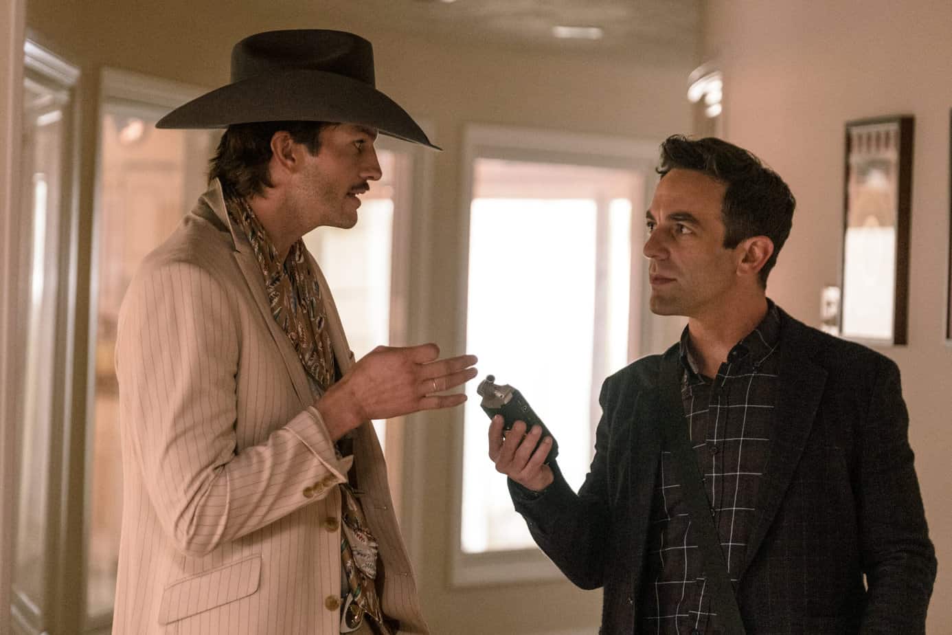 Two men talking, one in a dark suit one in a white suit with a cowboy hat. When can you take a bathroom break during vengeance. 