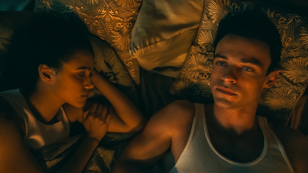 At what age can I watch Invitation 2022?  Parents submit an age rating review.  couple lies in bed together in clothes.