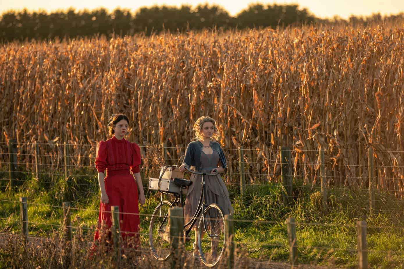 age rating for pearl: parents guide. Can your teens and tweens see this one? Two women walking near a corn field pushing a bicycle. 