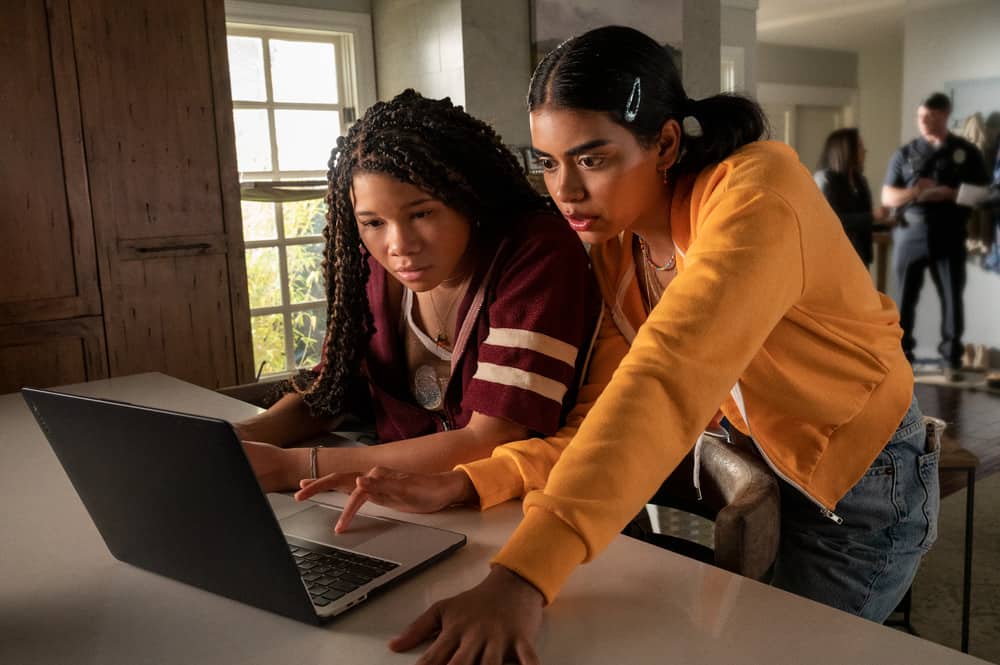 age rating of missing 2023 movie parents guide. two girls looking at a laptop computer.