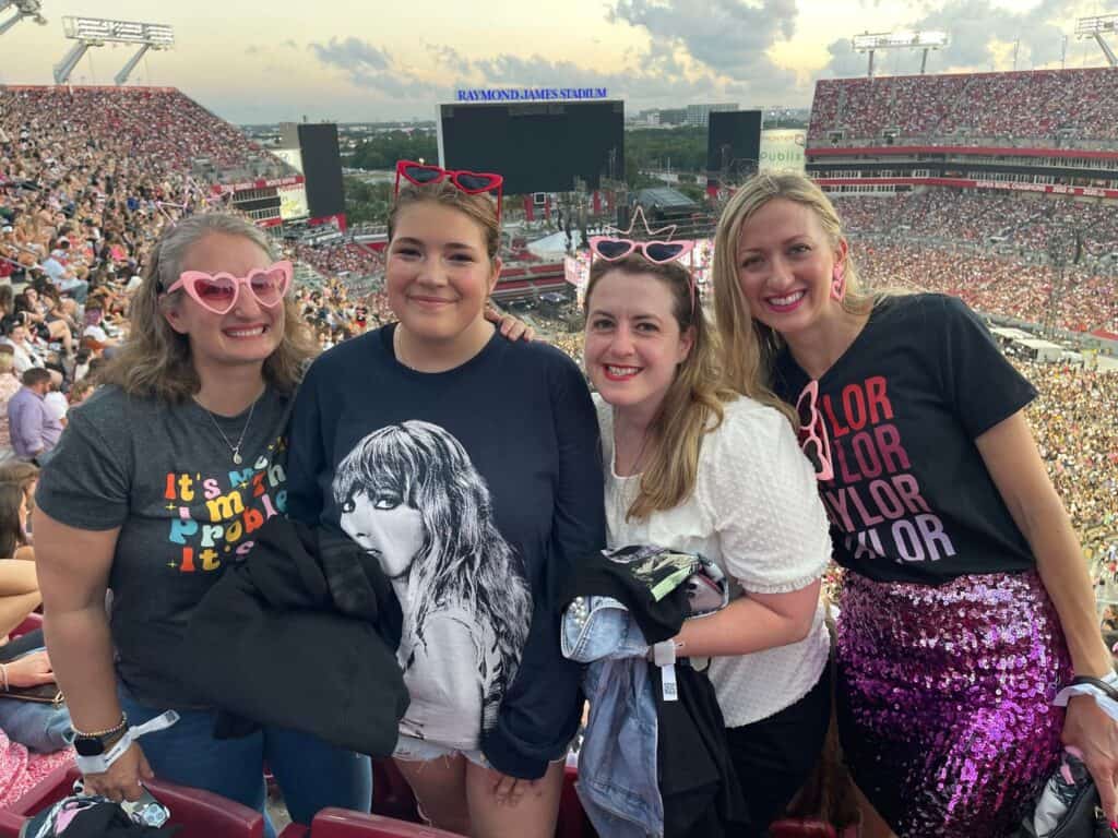 guide to eras tour with kids. 3 adults and 1 teen at the Taylor Swift concert. 